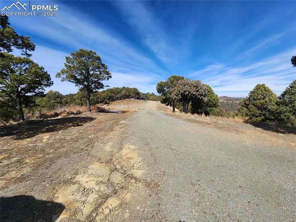 Image 4 of 23: View of dirt / gravel road with a rural view