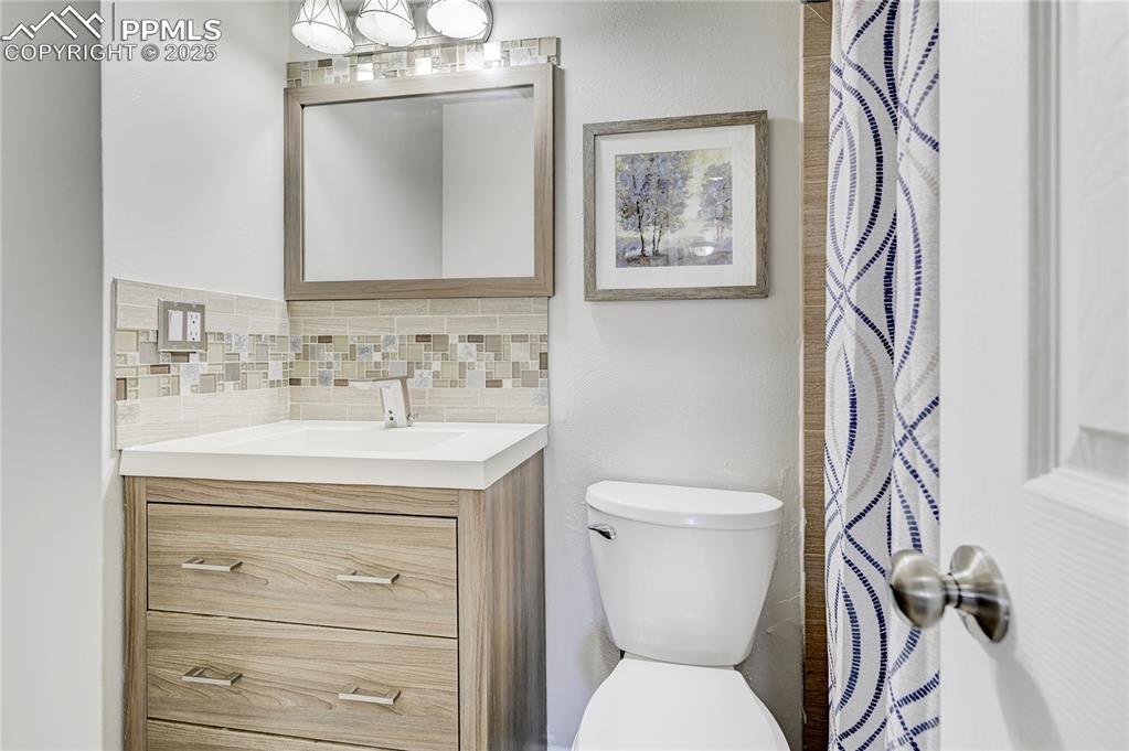 Image 10 of 26: Full bath featuring tasteful backsplash, vanity, and toilet