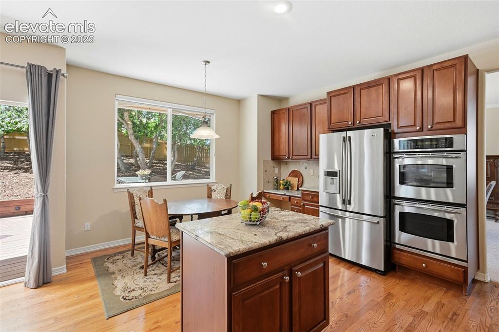 Image 12 of 50: The kitchen has lovely views of the backyard and access to the deck!