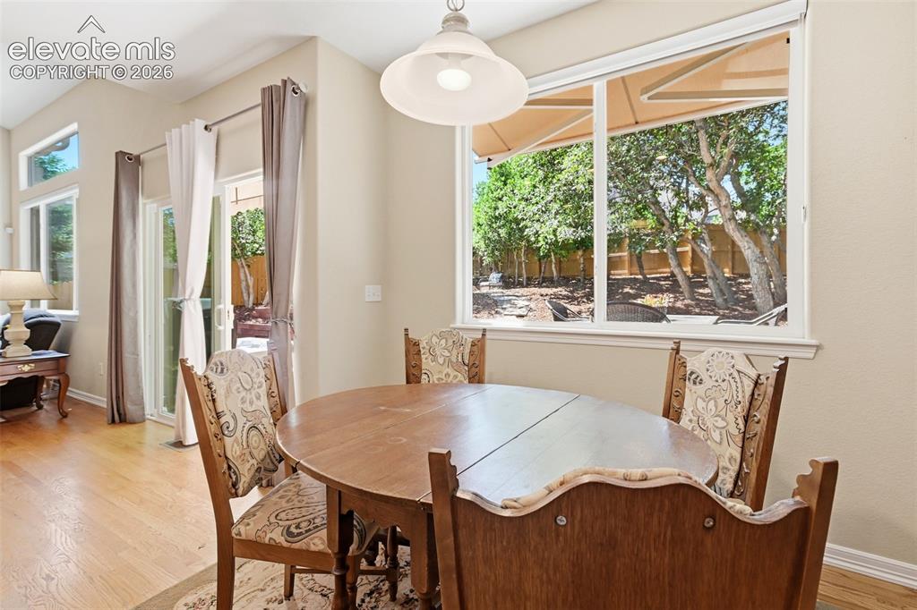 Image 17 of 50: Breakfast nook and door to backyard and deck.