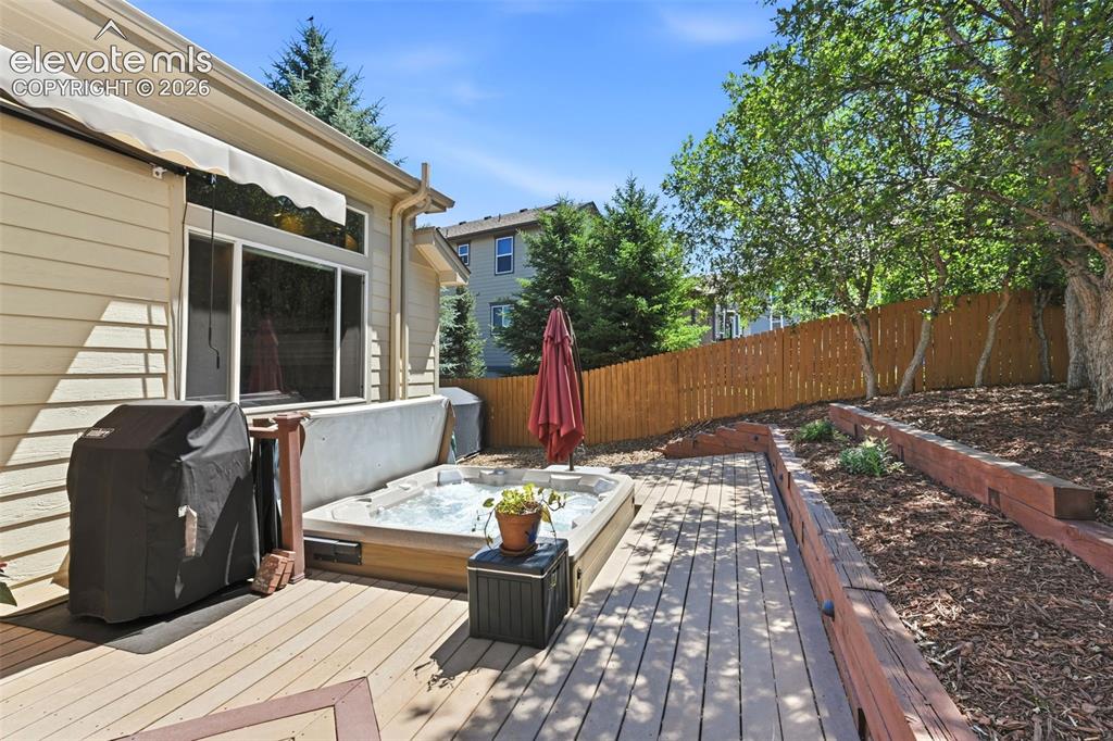 Image 22 of 50: The deck space includes a hot tub and room to grill!