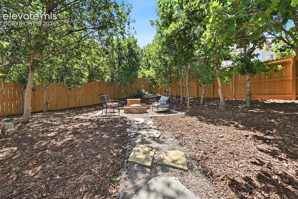 Image 24 of 50: Back yard and gas fire pit