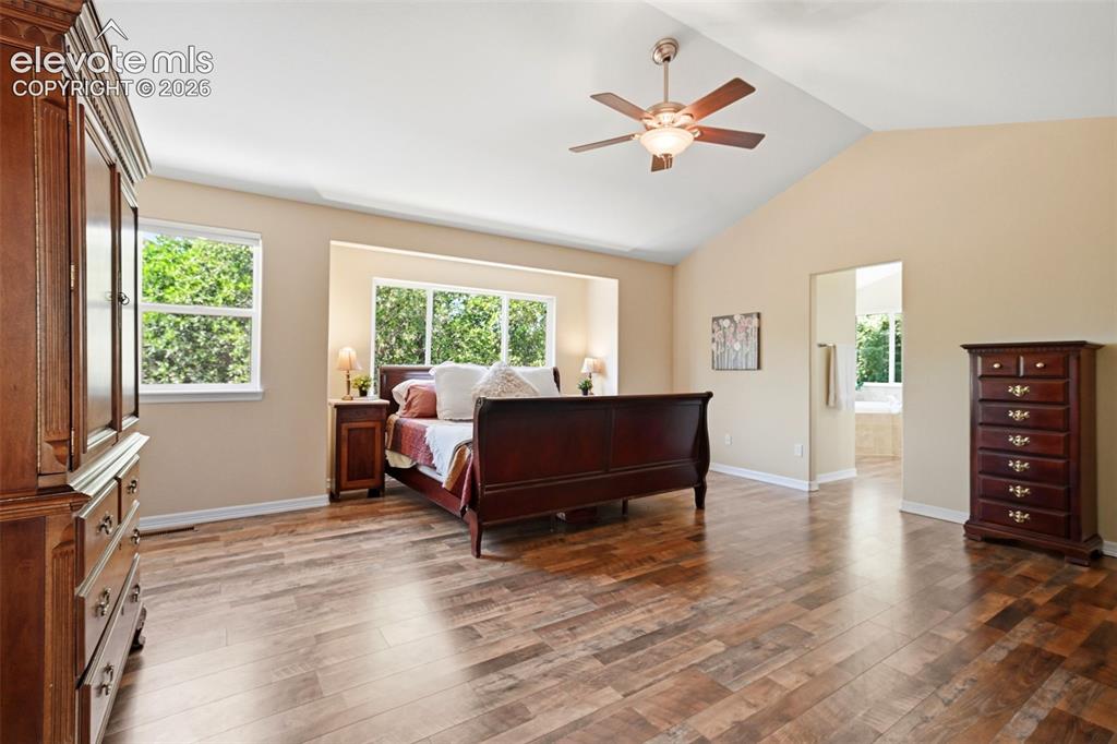 Image 30 of 50: Abundant natural light and beautiful hardwood flooring in the primary bedro