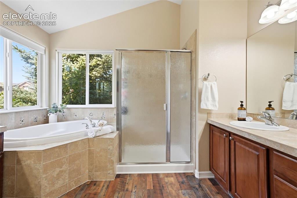 Image 35 of 50: Primary bath includes a soaking tub and lots of natural light.