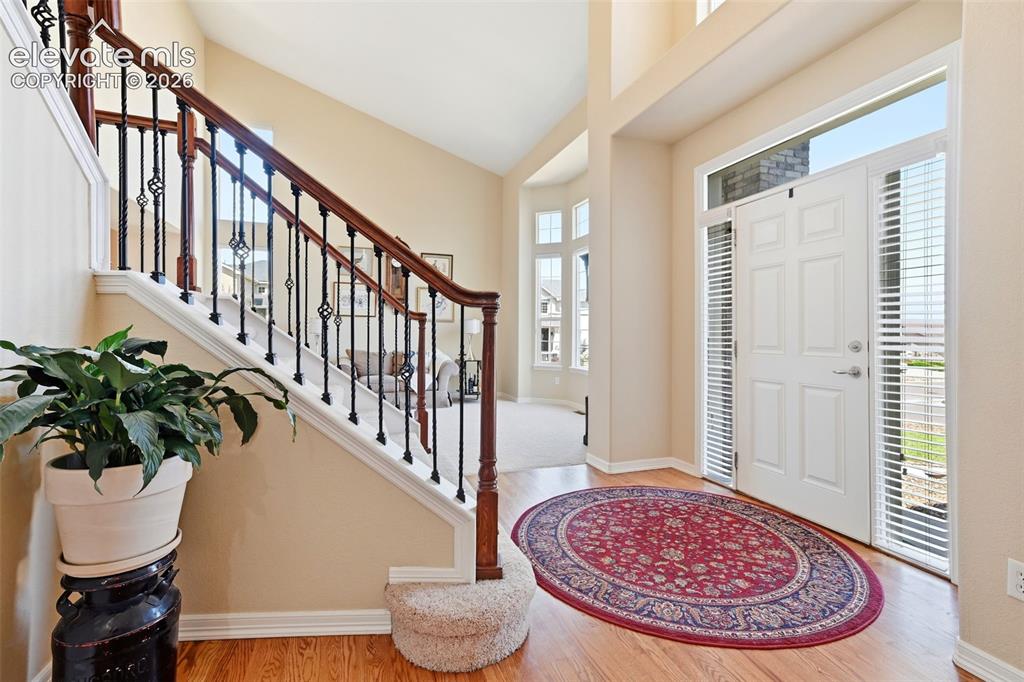 Image 4 of 50: Inviting entry way with natural wood flooring