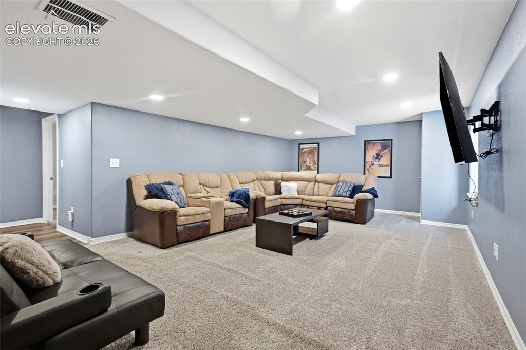 Image 41 of 50: The large basement media area is ideal for a movie night!