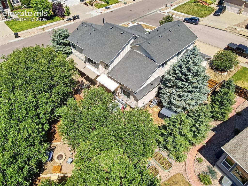 Image 48 of 50: Beautiful mature trees surround the home