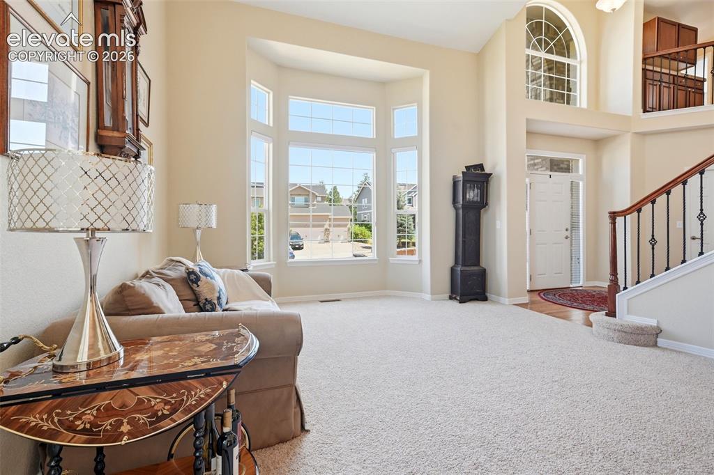 Image 7 of 50: Abundant natural light throughout the living room and front entry.