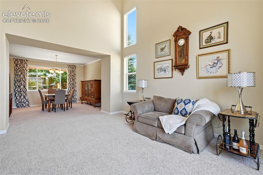 Image 8 of 50: Living room and dining area.
