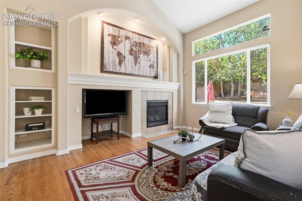 Image 9 of 50: Enjoy the cozy family room with gas fireplace and built-in shelving!