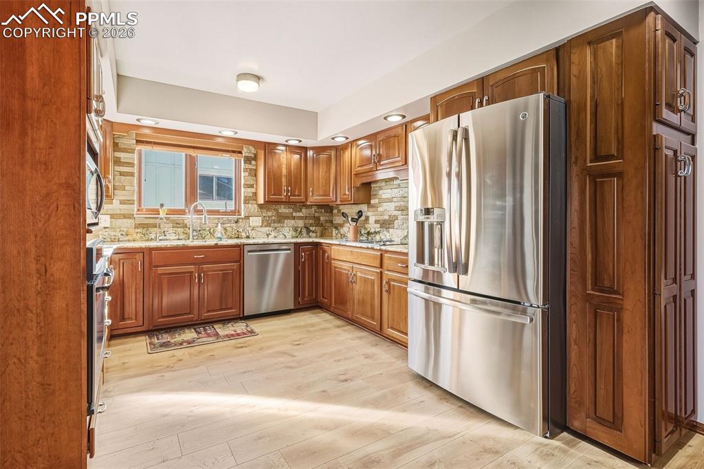 Image 12 of 50: Well-appointed kitchen with stainless steel appliances, abundant cabinetry,