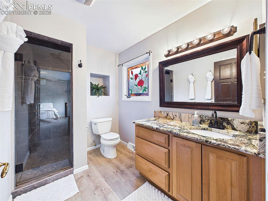 Image 19 of 50: Updated three-quarter bath featuring a refinished walk-in shower, granite c