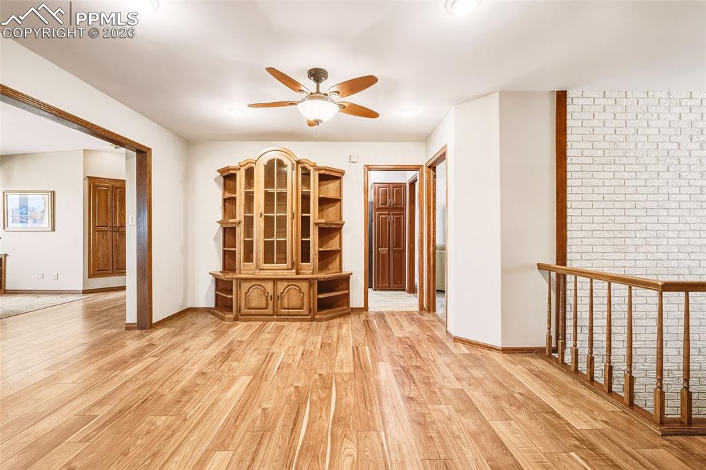 Image 3 of 50: Open landing with updated flooring and natural light provides flexible spac