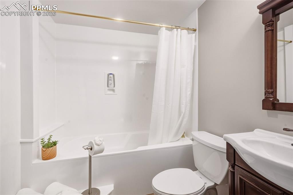 Image 35 of 50: Clean and bright full bath featuring a tub/shower combination with durable