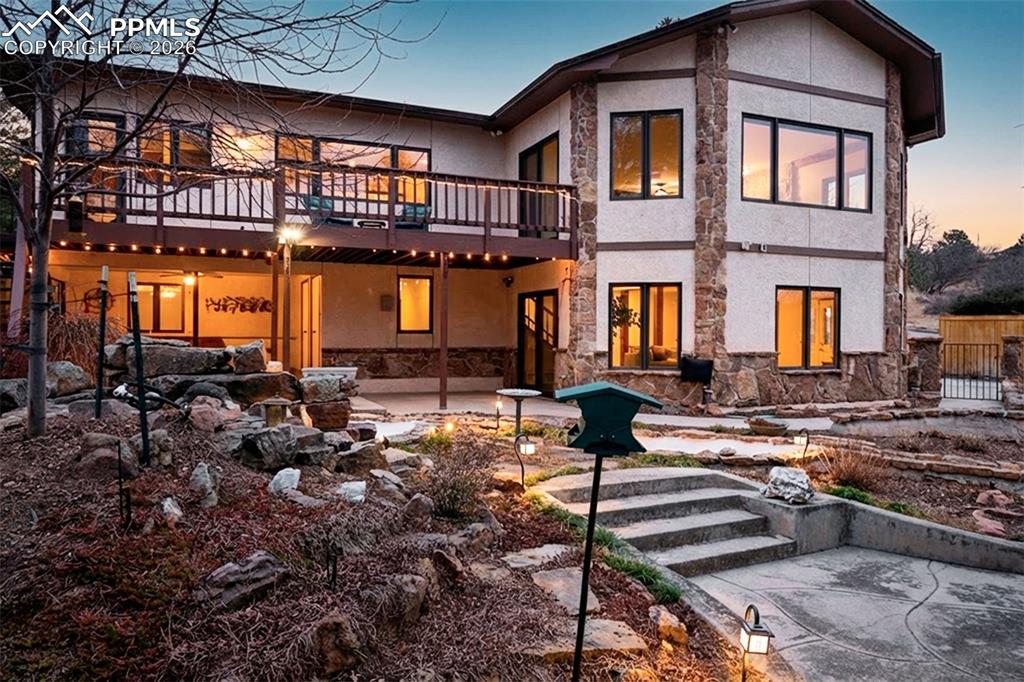 Image 41 of 50: Stunning evening ambiance highlights the multi-level outdoor living spaces,