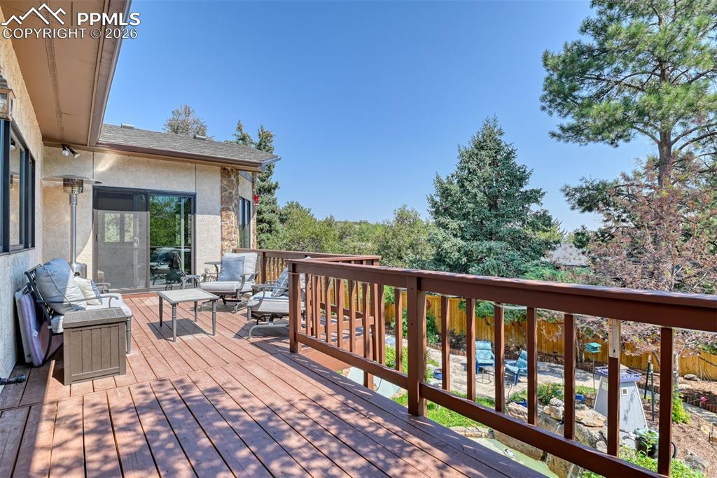 Image 44 of 50: Private outdoor retreat with ample room for seating, treetop views, and sea