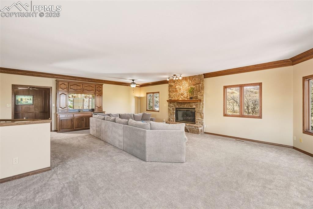 Image 9 of 50: Generous gathering space with abundant natural light and warm wood trim det
