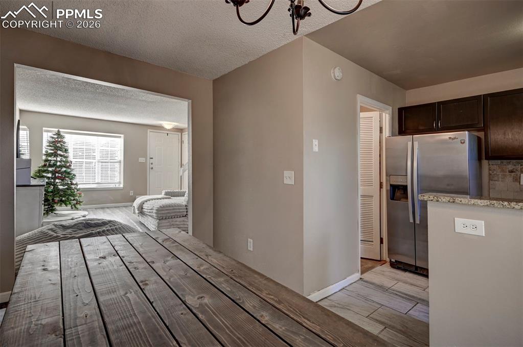 Image 11 of 31: View of the Living Room from the Dining Area and Kitchen.