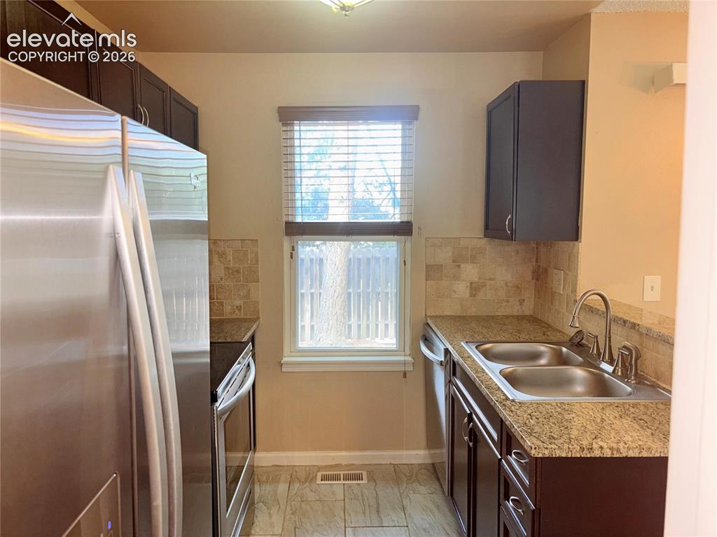 Image 12 of 31: The Kitchen features wood cabinets with countertops and stainless steel app