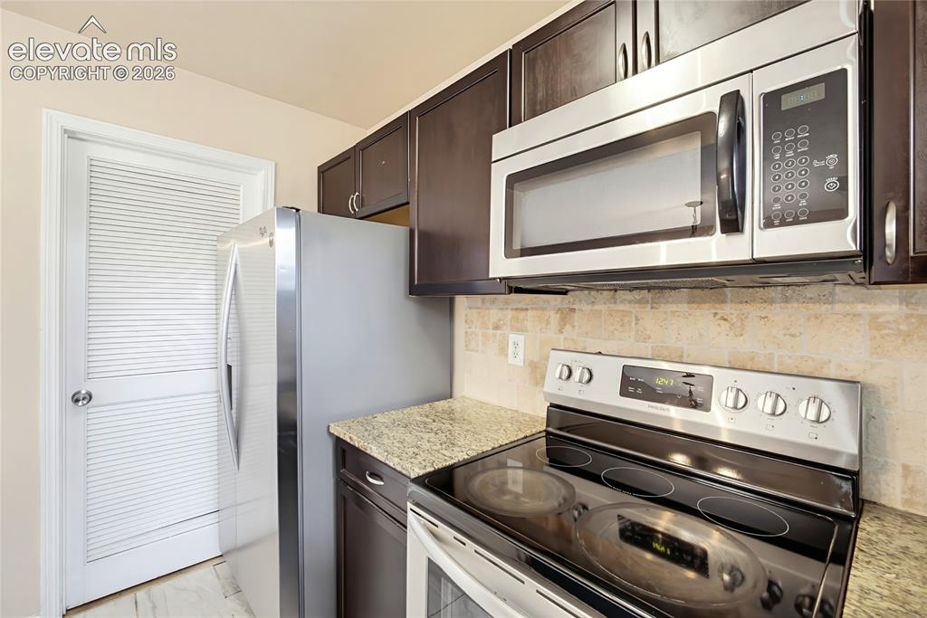 Image 12 of 31: Smooth top range oven, built in microwave oven, and side by side stainless