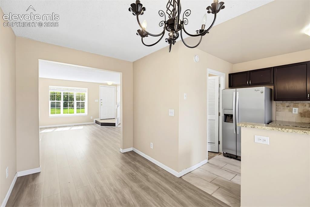 Image 14 of 31: Dining Area with views into the Living Room.