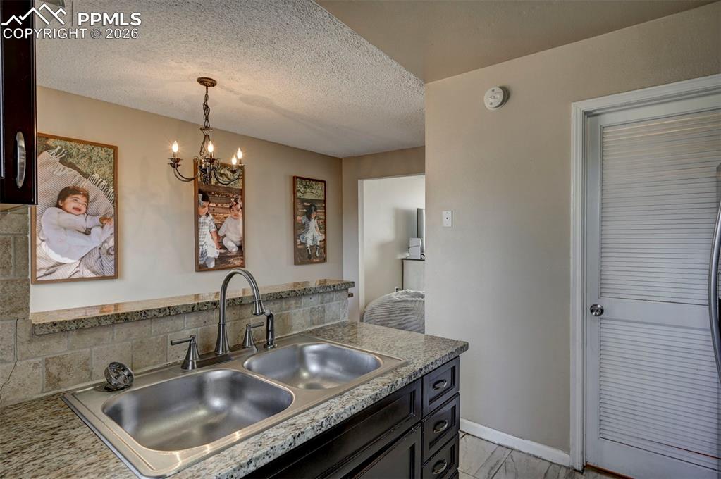 Image 16 of 31: The Kitchen overlooks the Dining Area and includes a double stainless steel