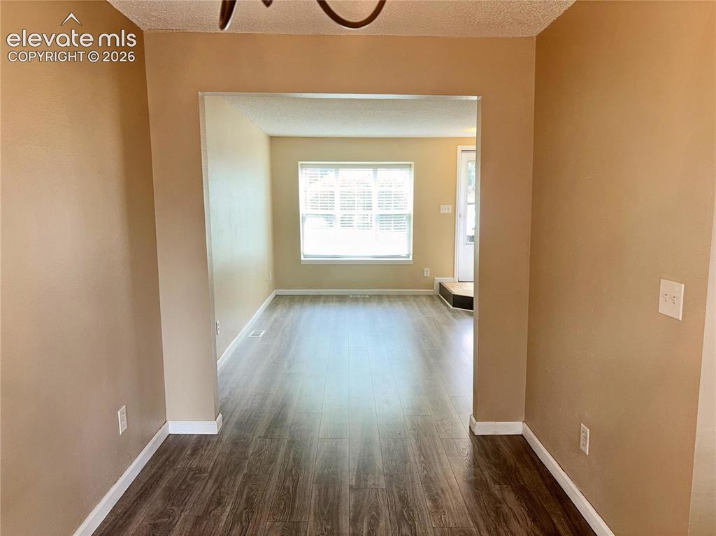 Image 16 of 31: View of the Living Room from the Dining Area.