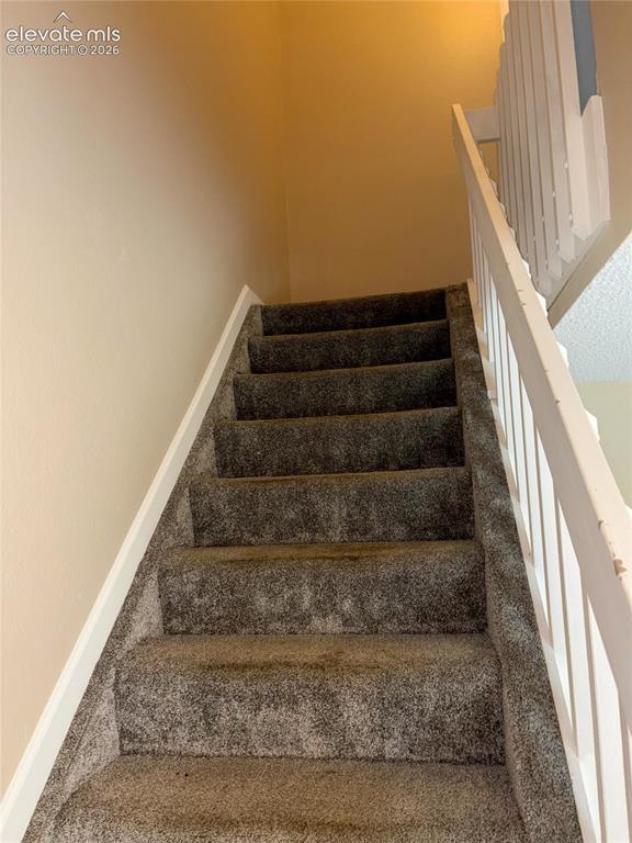 Image 17 of 31: Stairs to the upper level.