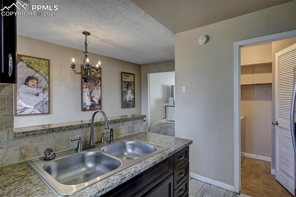 Image 18 of 31: The Laundry Room is located off the Kitchen.