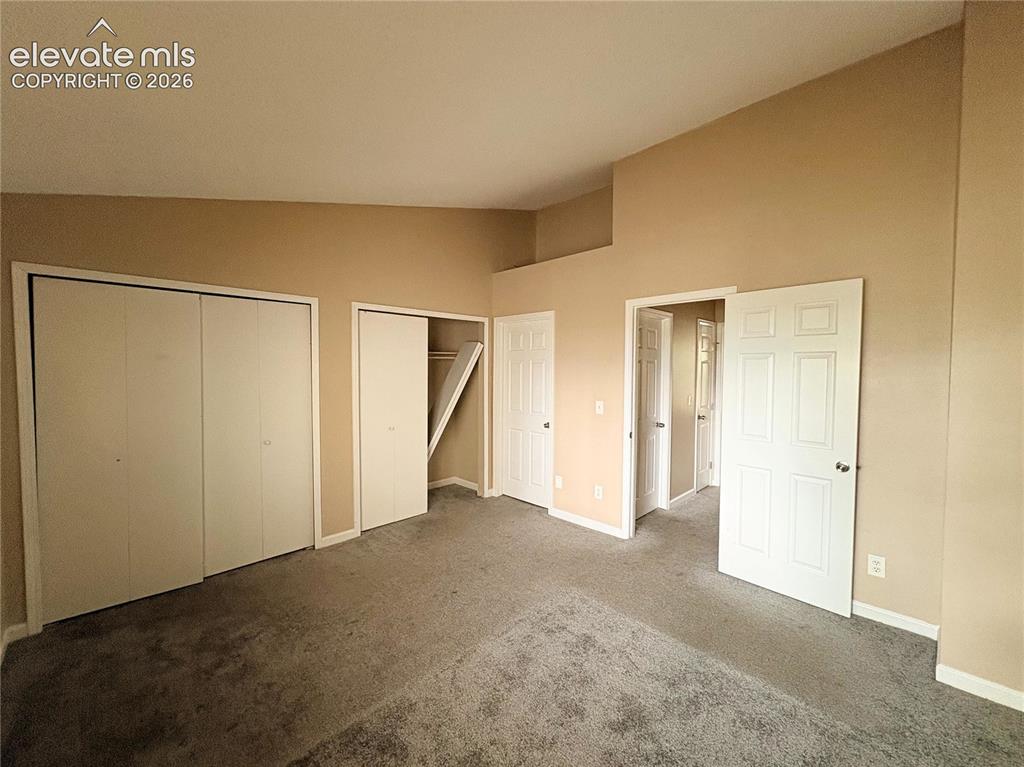 Image 19 of 31: Double closets in the Primary Bedroom and view into the adjoining Full Bath