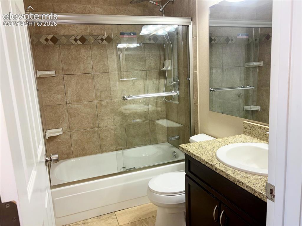 Image 20 of 31: Upper Level Bathroom includes a vanity, mirror, and tiled tub/shower
