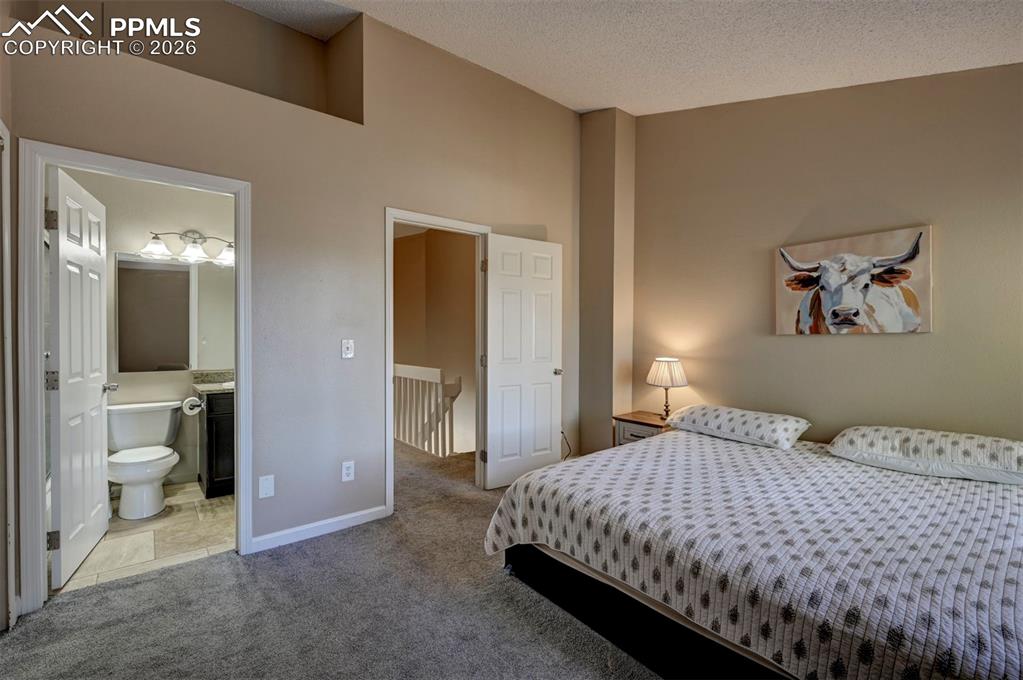 Image 22 of 31: Double closets in the Primary Bedroom and view into the adjoining Full Bath