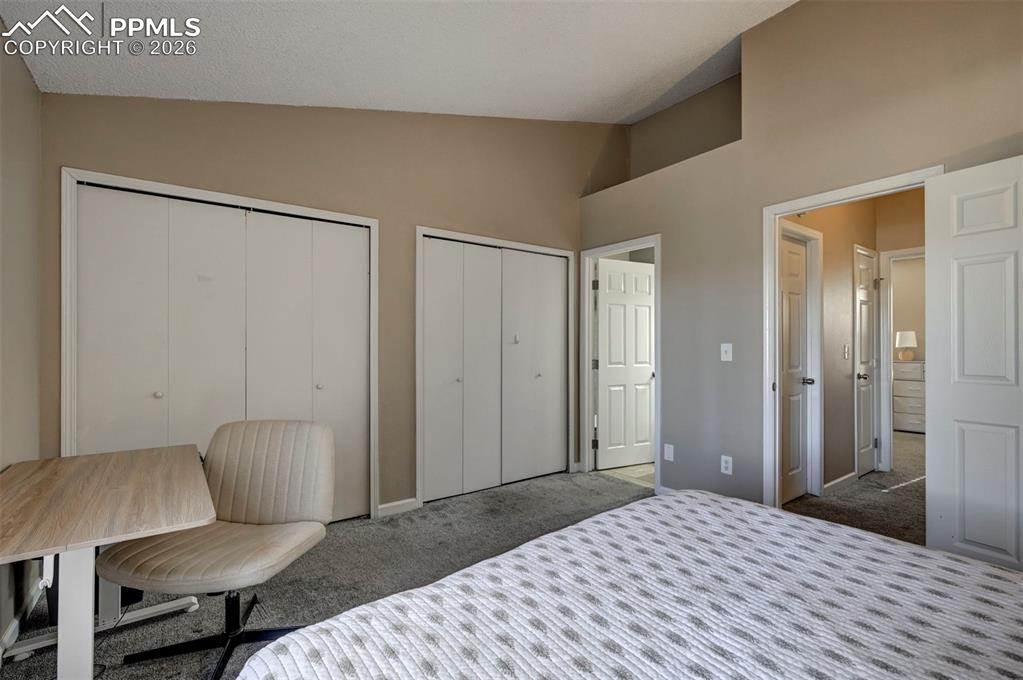 Image 24 of 31: The Upper Level Primary Bathroom features a vanity, mirror, and tiled tub/s