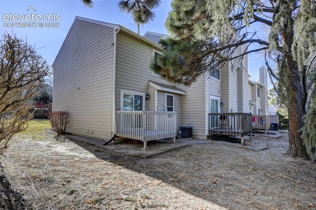 Image 25 of 31: Side and backyard views of the end unit townhome.