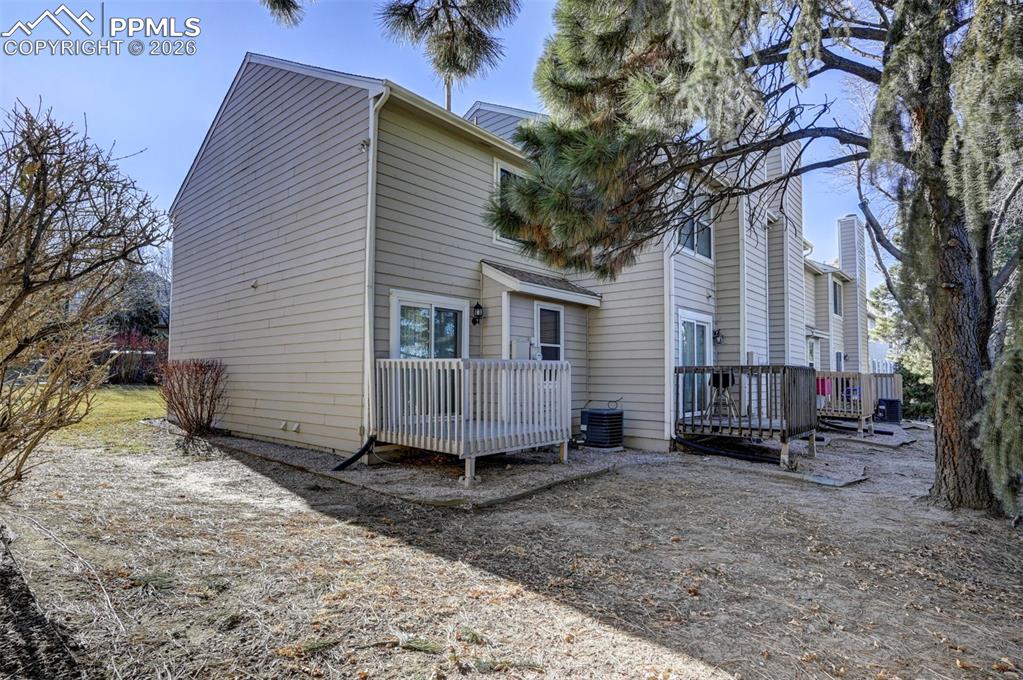 Image 28 of 31: Side and backyard views of the end unit townhome.