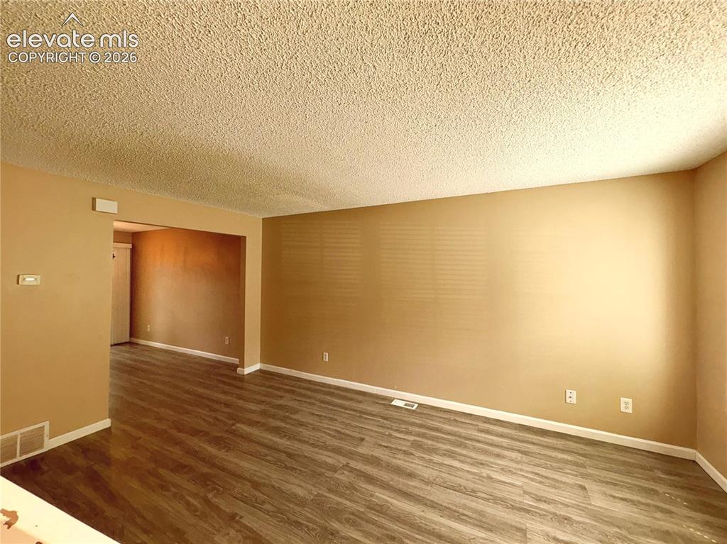 Image 3 of 31: Spacious Living Room with LVP flooring for comfortable everyday living and