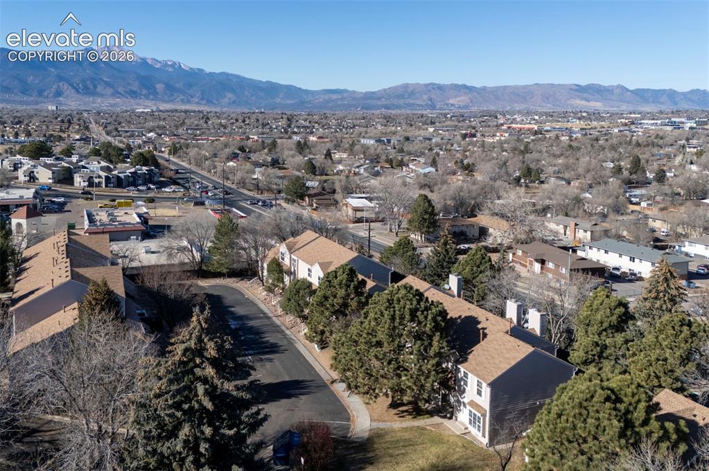 Image 30 of 31: Aerial view of townhome complex and mountain views.