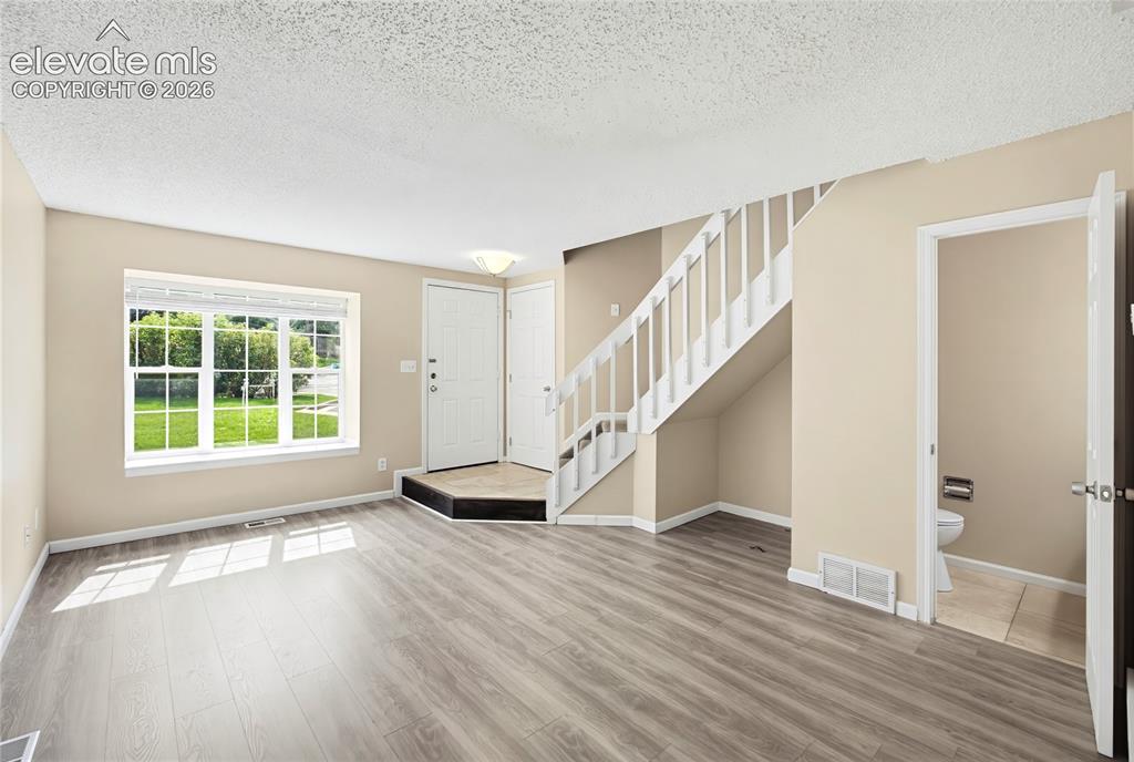 Image 4 of 31: Spacious Living Room with LVP flooring for comfortable everyday living and