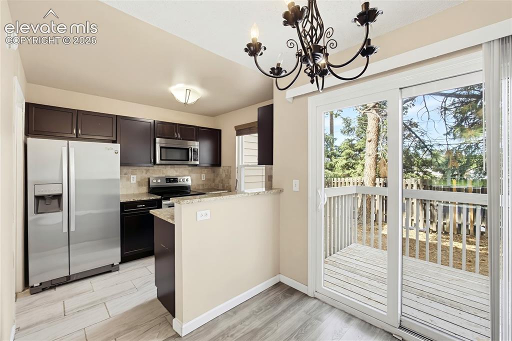 Image 7 of 31: The Dining Area is located off the Kitchen making it easy for entertaining
