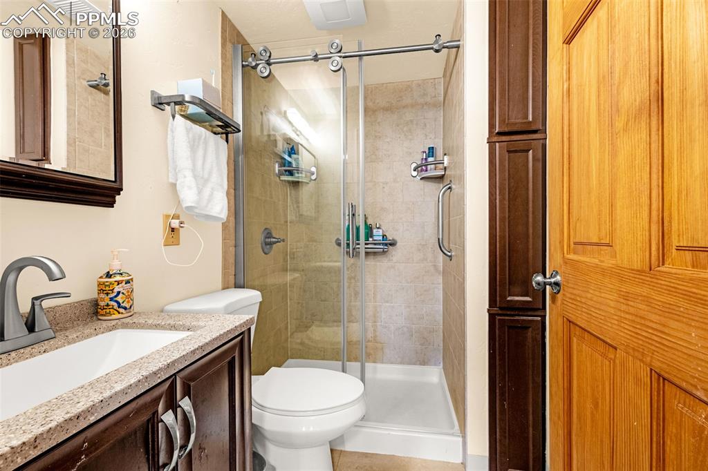 Image 15 of 38: Bathroom featuring vanity and a shower stall