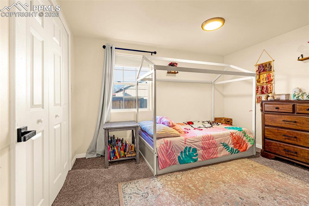Image 16 of 38: Bedroom with light carpet and baseboards