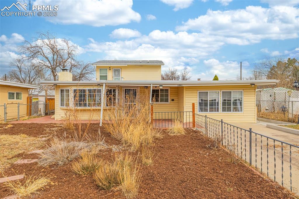 Image 2 of 38: Back of house featuring a chimney