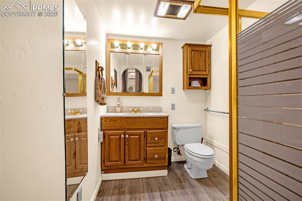 Image 24 of 38: Full bath featuring vanity and dark wood-style flooring