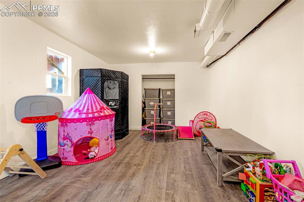 Image 26 of 38: Playroom featuring wood finished floors