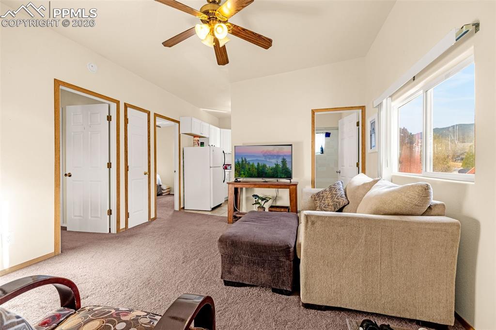 Image 28 of 38: ADU Living area featuring light colored carpet and ceiling fan
