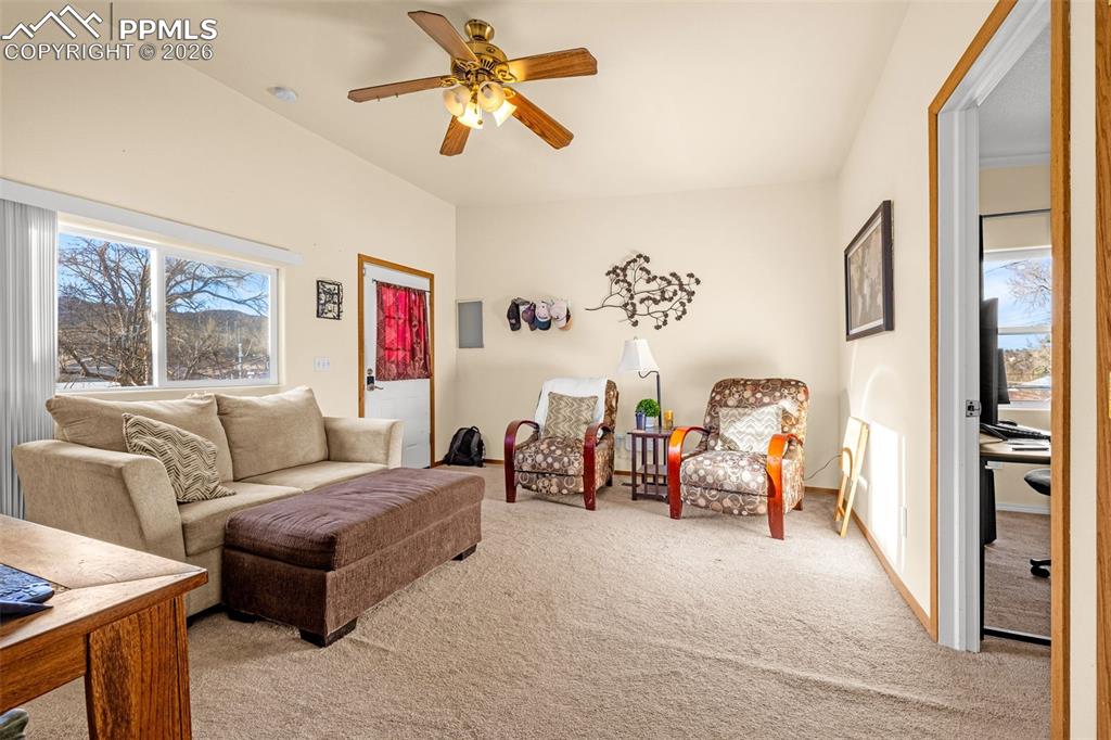 Image 29 of 38: ADU Living area with a ceiling fan and light carpet