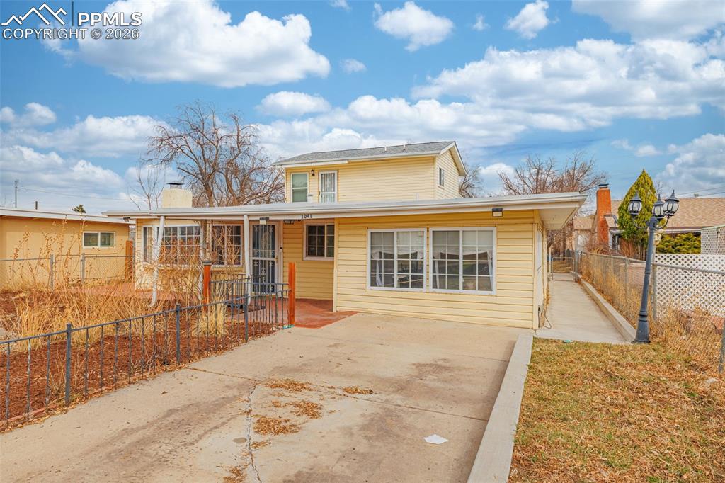 Image 3 of 38: Traditional home with a chimney and concrete driveway