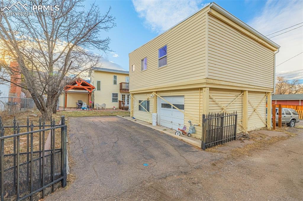 Image 37 of 38: View of ADU property exterior featuring a patio, an attached garage, and as