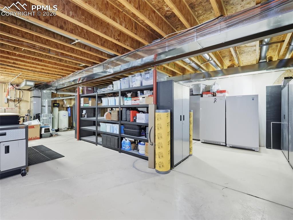 Image 35 of 50: Gigantic storage area. The shelving, the safe, and extra water tanks are al
