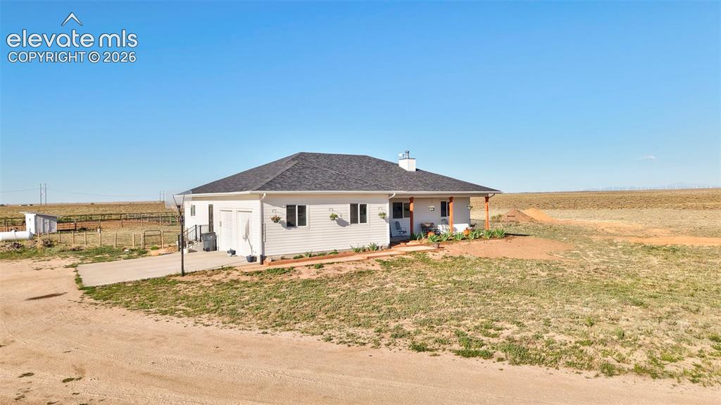 Image 3 of 50: Front of Home with parking, garage and basketball hoop